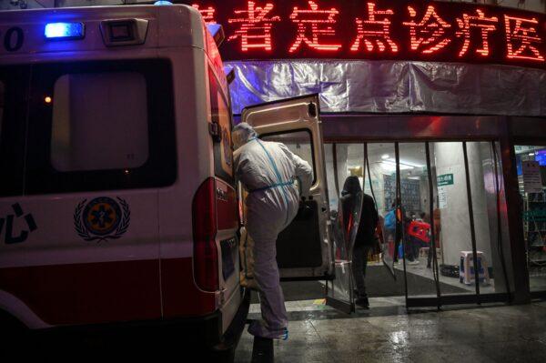 A medical staff member wearing protective clothing to help stop the spread of a deadly virus which began in the city is seen on an ambulance at the Wuhan Red Cross Hospital in Wuhan on Jan. 25, 2020. (Hector Retamal/AFP via Getty Images)