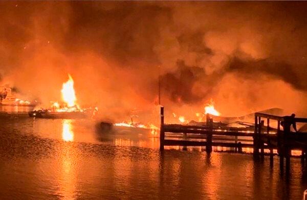 A fire burns on a dock where at least 35 vessels, many of them houseboats, were destroyed by fire early on Jan. 27, 2020, in Scottsboro, Ala. (DeWayne Patterson/Jackson County Sentinel via AP)