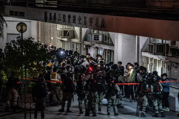 Riot police detain a mass amount of residents in Fanling district in Hong Kong, China, on Jan. 26, 2020. Protesters clash over a proposal of using newly constructed housing as a quarantine site in a residential area. (Anthony Kwan/Getty Images)
