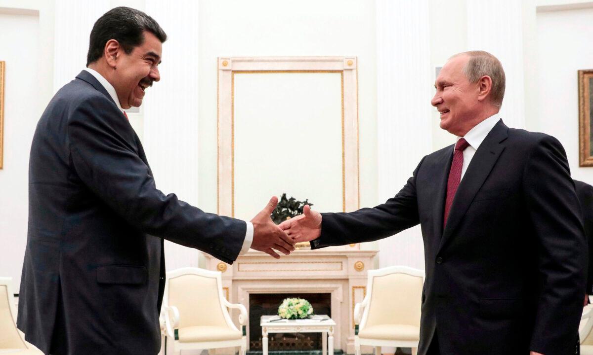 Russian President Vladimir Putin (R) shakes hands with Venezuelan President Nicolas Maduro during their meeting at the Kremlin in Moscow on Sept. 25, 2019. (Sergei Chirikov/AFP via Getty Images)