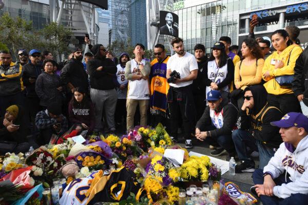 People gather at a memorial for Kobe Bryant near Staples Center after the death of Bryant in Los Angeles, on Jan. 26, 2020. (Michael Owen Baker/AP Photo)