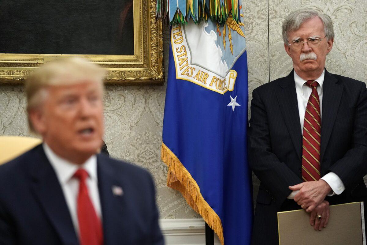 White House National Security Advisor John Bolton, right, listens to President Donald Trump speak in the Oval Office of the White House on July 18, 2019. (Chip Somodevilla/Getty Images)