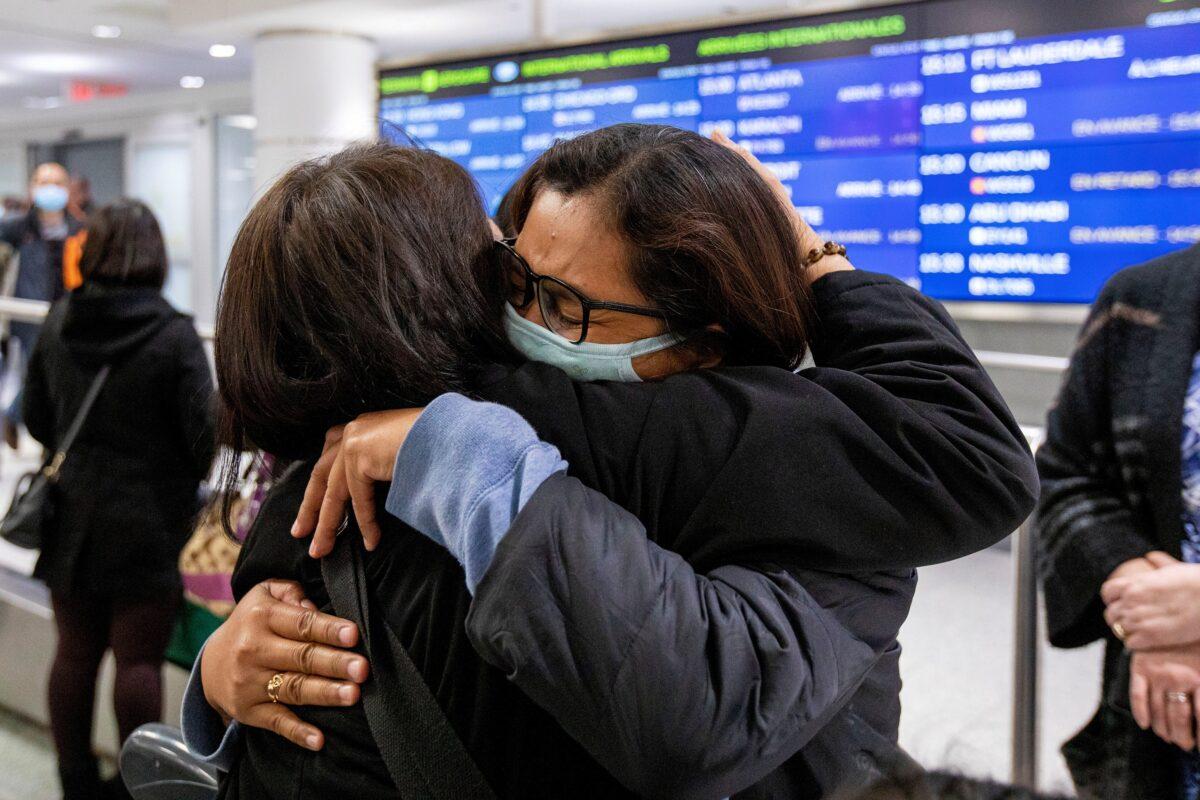 Mary Grace Baguio hugs a relative after arriving on a flight from Hong Kong at Pearson airport arrivals, shortly after Toronto Public Health received notification of Canada's first presumptive confirmed case of coronavirus, in Toronto, Ontario, Canada on Jan. 26, 2020. (Carlos Osorio/Reuters)