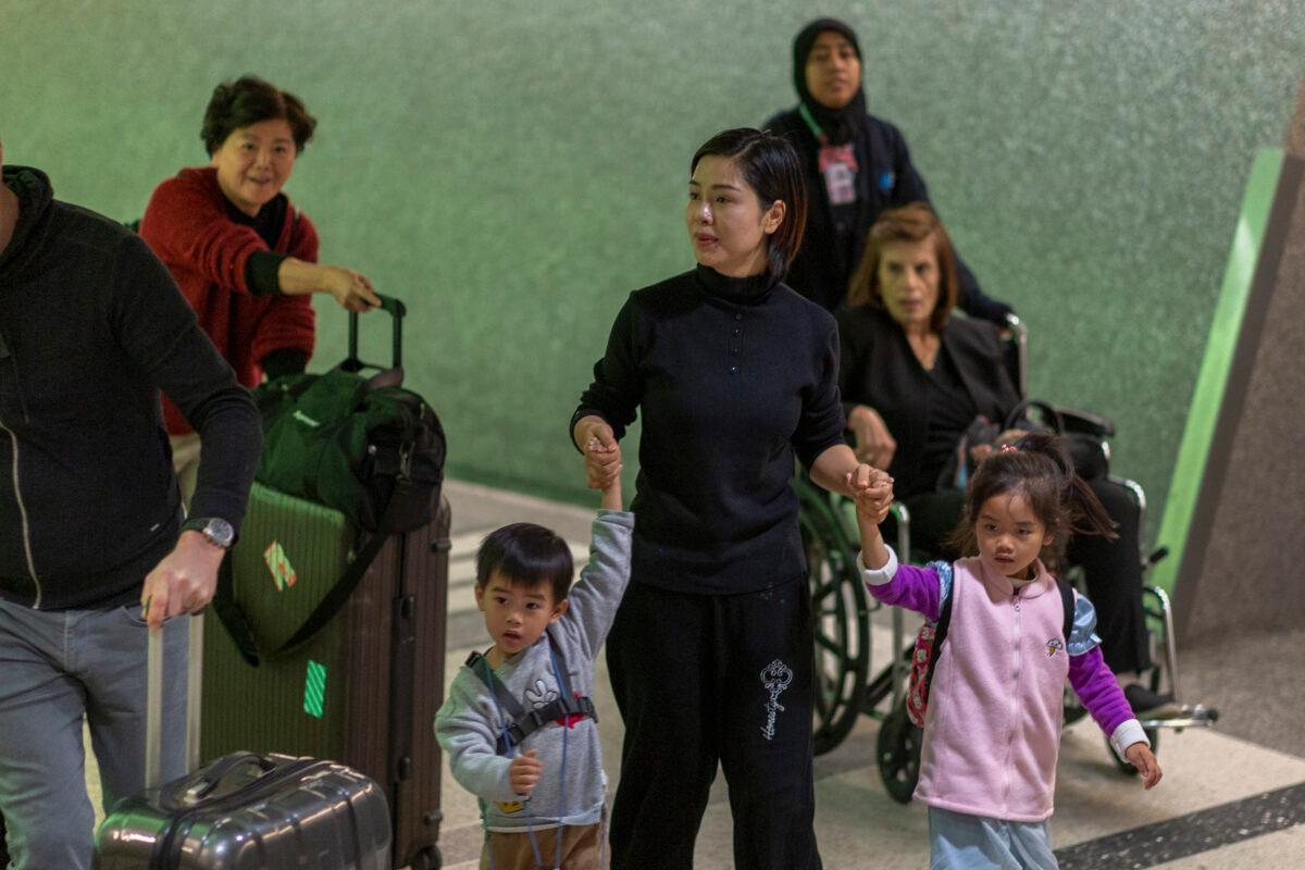 People arrive at Los Angeles International Airport after landing of an Air China flight from Beijing, which serves as a connector from Wuhan, China, to Los Angeles, on the first day of health screenings for coronavirus of travelers from Wuhan on Jan. 18, 2020. (David McNew/Getty Images)