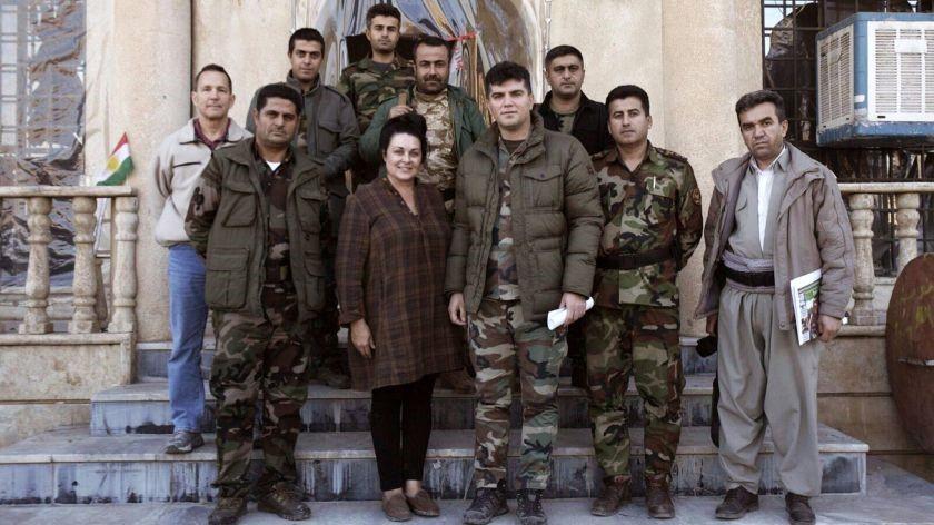 Kelly Galindo with Kurdish soldiers while filming her documentary “26 Seconds” in Iraq. The commander of the group assigned soldiers to watch over Galindo as she filmed. (Courtesy of Alberto De Coste Calla)