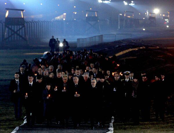Diginitaries arrive to put candles at a memorial site at the Auschwitz Nazi death camp in Oswiecim, Poland, on Jan. 27, 2020. (Czarek Sokolowski/AP Photo)
