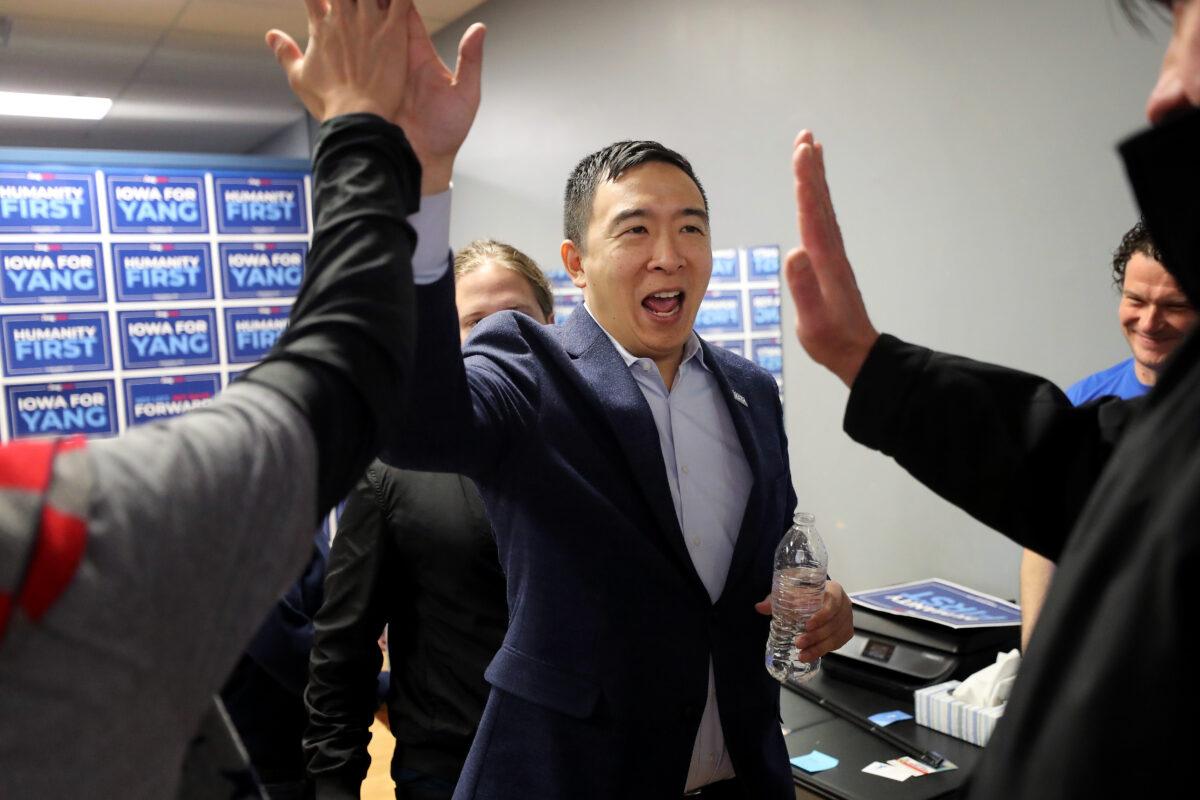 Democratic presidential candidate Andrew Yang gives high-fives to campaign volunteers following a town hall meeting at Penn Central Mall in Oskaloosa, Iowa, on Jan. 25, 2020. (Chip Somodevilla/Getty Images)