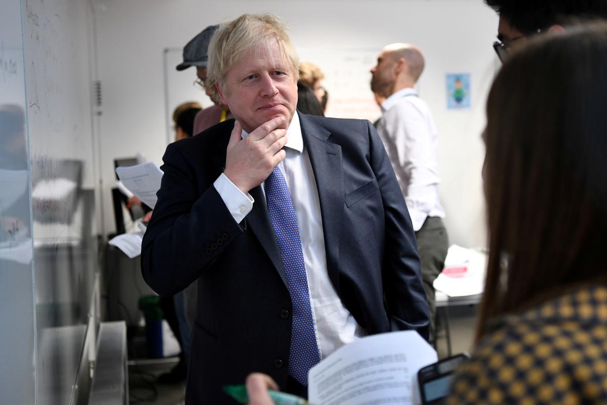 Britain's Prime Minister Boris Johnson reacts as he listens to students solving maths questions during his visit to the Department of Mathematics at King's Maths School, part of King's College London University, in central London, Britain on Jan. 27, 2020. (Daniel Leal-Olivas/Pool via Reuters)