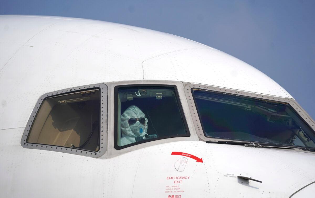 A pilot wearing a protective suit parks a cargo plane at Wuhan Tianhe International Airport in Wuhan in central China's Hubei Province on Jan. 28, 2020. (Cheng Min/Xinhua via AP)