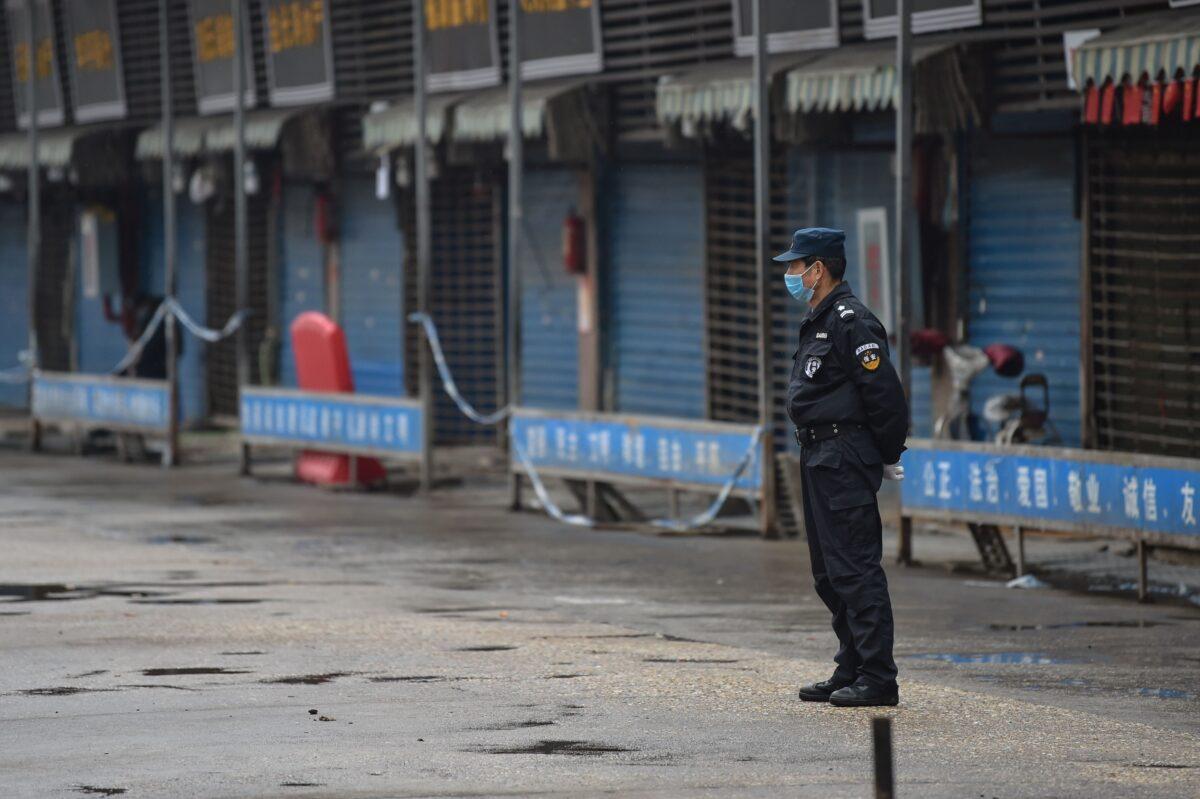 A security guard stands outside the Huanan Seafood Wholesale Market, where the coronavirus was detected, in Wuhan, China on Jan. 24, 2020. (Hector Retamal/AFP via Getty Images)