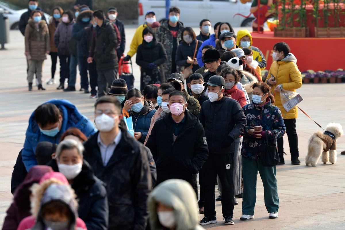 People line up to buy face masks at a drug store in Nanjing in eastern China's Jiangsu Province, on Jan. 29, 2020. (Chinatopix via AP)