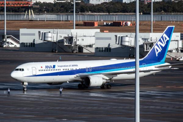 An airplane carrying Japanese citizens repatriated from Wuhan amidst the coronavirus outbreak lands at Haneda airport in Tokyo, on Jan. 29, 2020. (Carl Court/Getty Images)