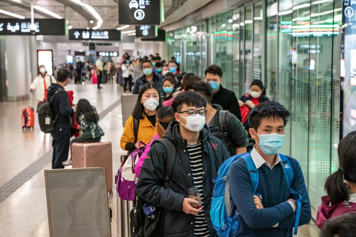 Travelers wearing protective masks wait in line for taxi after arriving at Hong Kong High Speed Rail Station in Hong Kong, China, on Jan. 29, 2020. (Anthony Kwan/Getty Images)