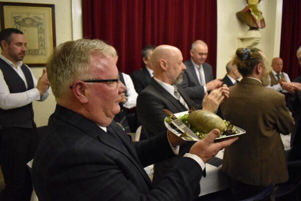 A haggis being brought in at the Burns Club in Dundee, Scotland, for the 160th annual Burns Supper on Jan. 25, 2020. (CC BY-SA 4.0)