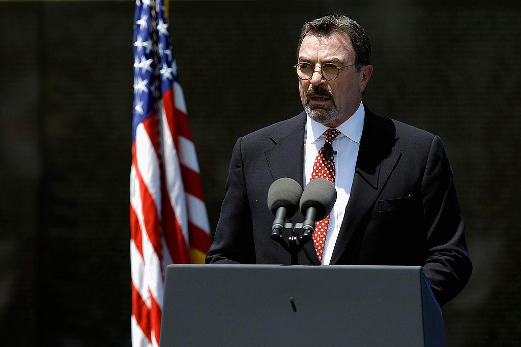 Selleck speaks on Memorial Day at the Vietnam Veterans Memorial on the National Mall in Washington, D.C., on May 28, 2012. (©Getty Images | <a href="https://www.gettyimages.com/detail/news-photo/actor-and-army-national-guard-veteran-tom-selleck-master-of-news-photo/145400331?adppopup=true">Chip Somodevilla</a>)