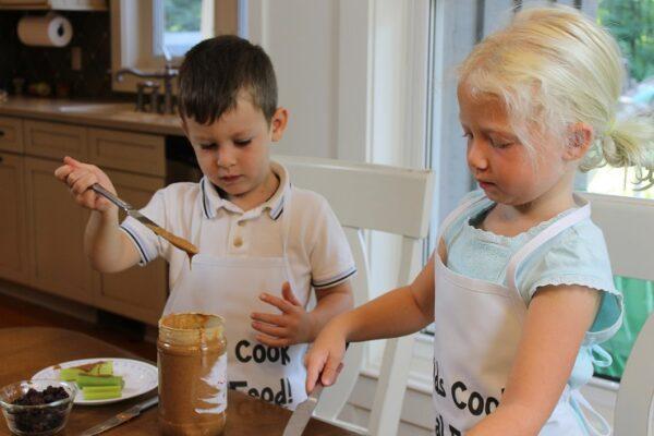 Two children participating in a beginner class of Kids Cook Real Food. (Courtesy of Katie Kimball)