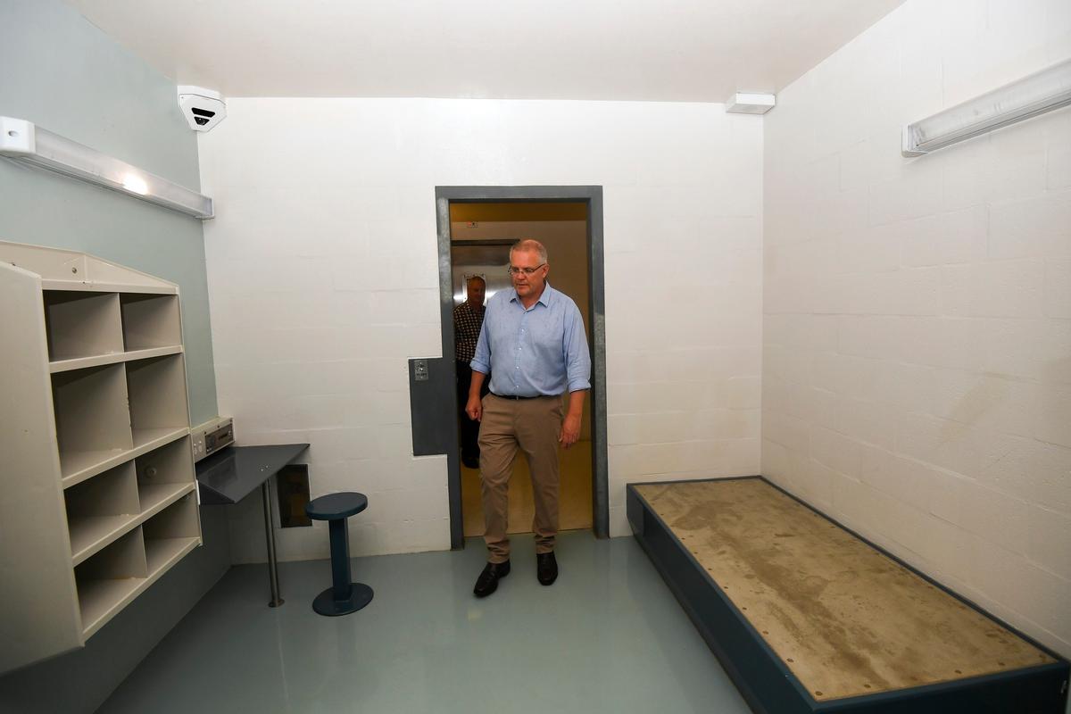 Australian Prime Minister Scott Morrison walks into a high care accommodation room as he tours the North West Point Detention Centre on Christmas Island on March 6, 2019. (Lukas Coch/AAP Image via AP)