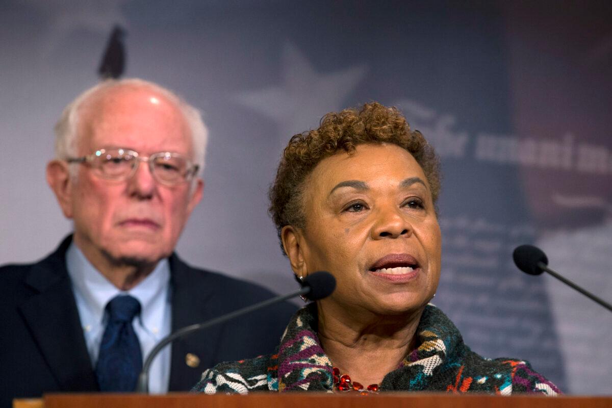 Rep. Barbara Lee (D-Calif.), flanked by Sen. Bernie Sanders (I-Vt.), speaks during a news conference on Capitol Hill in Washington regarding a measure limiting then-President Donald Trump's ability to take military action against Iran, on Jan. 9, 2020. (Jose Luis Magana/AP Photo)