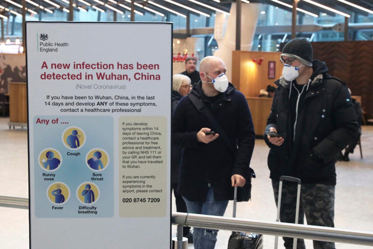 Passengers arrive at Heathrow Airport in London after the last British Airways flight from China touched down in the UK following an announcement that the airline was suspending all flights to and from mainland China with immediate effect amid the escalating coronavirus crisis, on Jan. 29, 2020. (Steve Parsons/PA via AP)