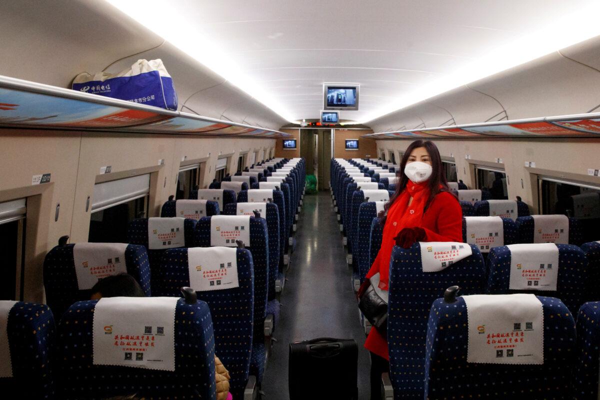 As the country is hit by an outbreak of a new coronavirus, a woman wears a mask as she travels on a high-speed train near Jiujiang, Jiangxi province, China, on Jan. 29, 2020. (Thomas Peter/Reuters)