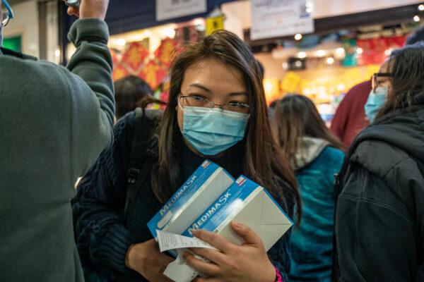 A woman purchases surgical masks at a store in a shopping mall on Jan. 29, 2020, in Hong Kong. (Anthony Kwan/Getty Images)