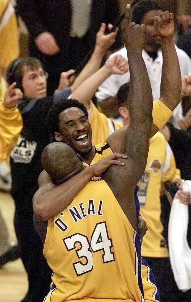 Bryant jumps into the arms of O'Neal as the Los Angeles Lakers win the NBA Championship in Los Angeles on June 19, 2000. (©Getty Images | <a href="https://www.gettyimages.com/detail/news-photo/kobe-bryant-jumps-into-the-arms-of-shaquille-oneal-as-the-news-photo/51549488?adppopup=true">DON EMMERT</a>)