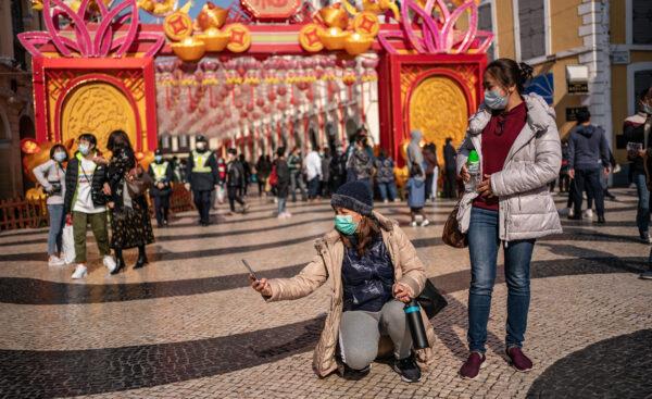 People wearing face masks take a selfie in Macau, China, on Jan. 28, 2020. (Anthony Kwan/Getty Images)
