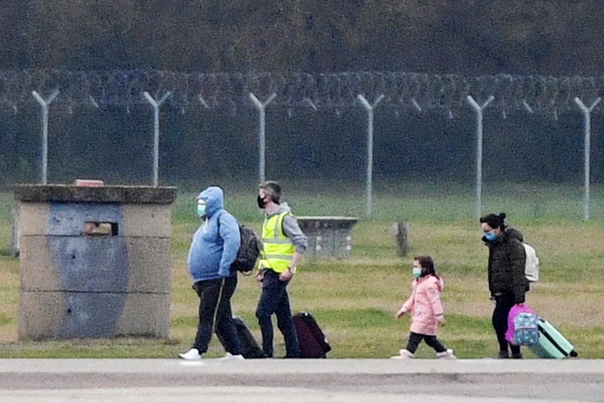 Some of the 83 Britons and 27 foreign nationals who were trapped in Wuhan following the coronavirus outbreak disembark from a plane in Brize Norton, England, on Jan. 31, 2020. (Leon Neal/Getty Images)
