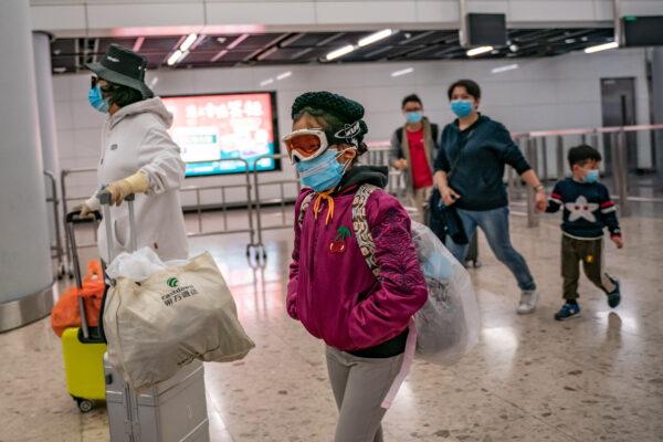 A girl wearing ski goggles and protective mask exits the arrival hall at Hong Kong High Speed Rail Station on Jan. 29, 2020. (Anthony Kwan/Getty Images)