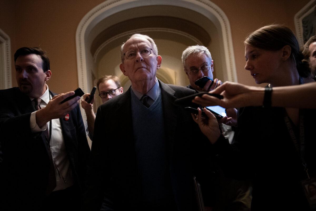 Sen. Lamar Alexander (R-Tenn.) walks with reporters after a meeting with Republicans about calling witnesses during the impeachment trial of President Donald Trump on Capitol Hill in Washington on Jan. 28, 2020. (Brendan Smialowski/AFP via Getty Images)