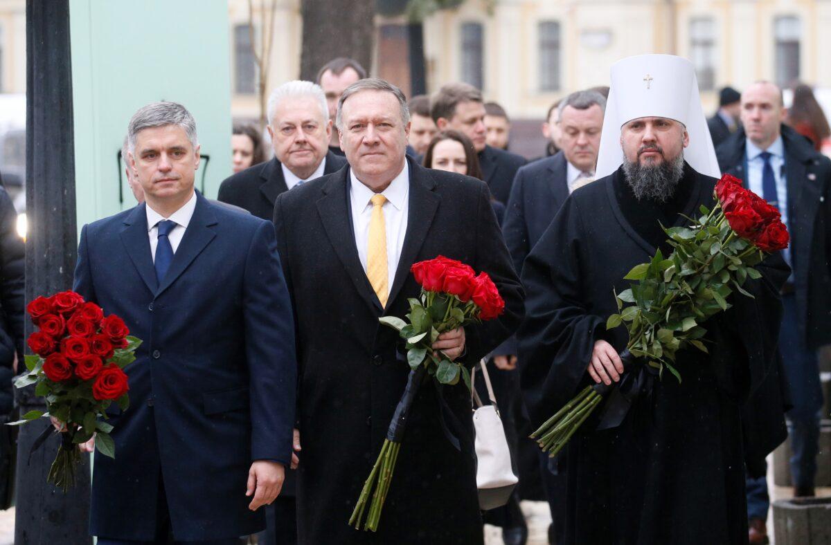 U.S. Secretary of State Mike Pompeo, Ukrainian Foreign Minister Vadym Prystaiko, and Metropolitan Epifaniy, head of the Orthodox Church of Ukraine, arrive to attend a ceremony at the memorial to Ukrainian soldiers, who were killed in a recent conflict in the country's eastern regions, in central Kyiv, Ukraine, on Jan. 31, 2020. (Valentyn Ogirenko/Reuters)