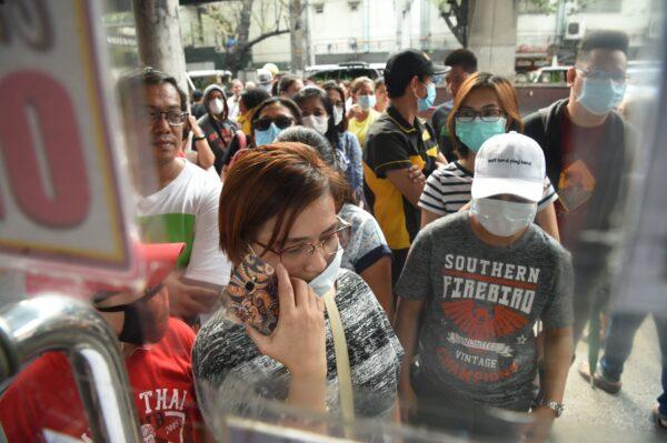People queue up to buy protective masks at a medical supplies store in Manila, Philippines, on Jan. 31, 2020. (Ted Aljibe/AFP via Getty Images)