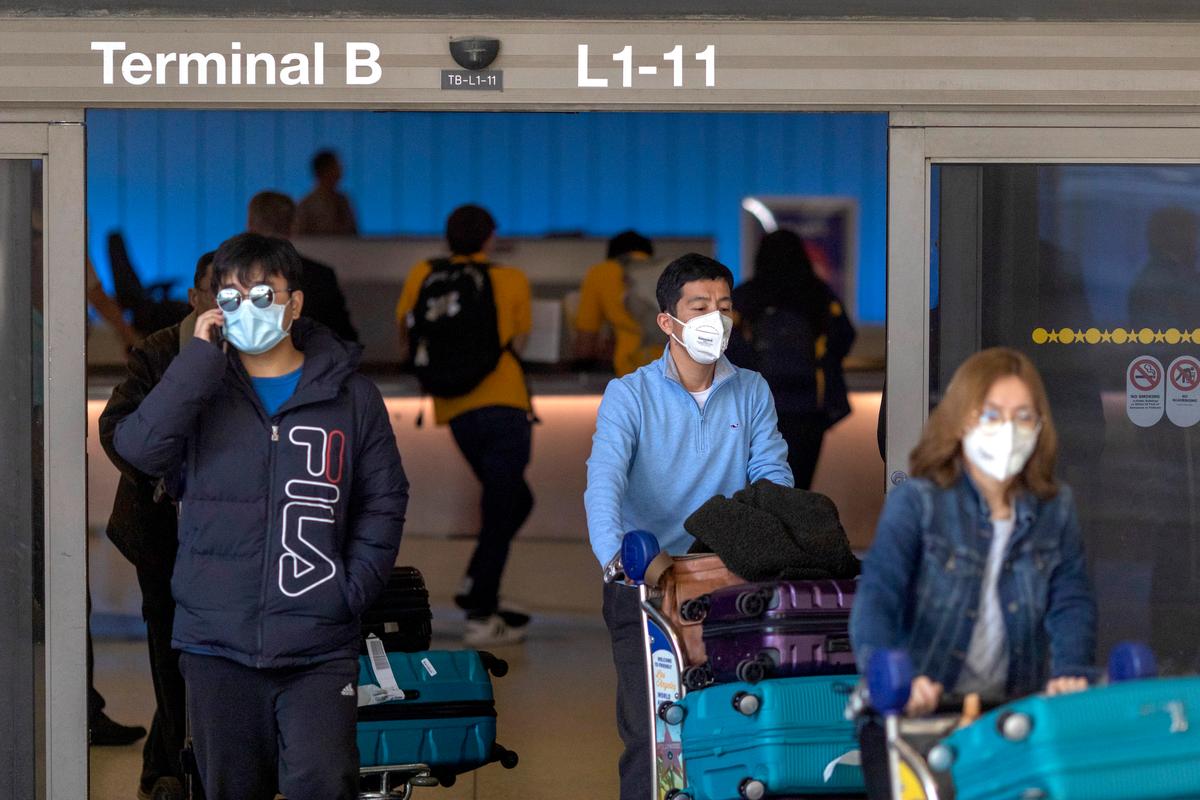 Travelers arrive to LAX Tom Bradley International Terminal wearing medical masks for protection against the novel coronavirus outbreak in Los Angeles, Calif., on Feb. 2, 2020. (David McNew/Getty Images)