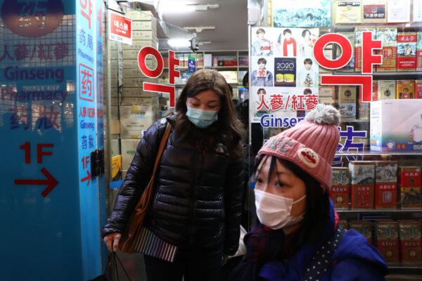 People leave after buying face masks at a pharmacy at Myeongdong shopping district in Seoul, South Korea, on Jan. 31, 2020. (Chung Sung-Jun/Getty Images)
