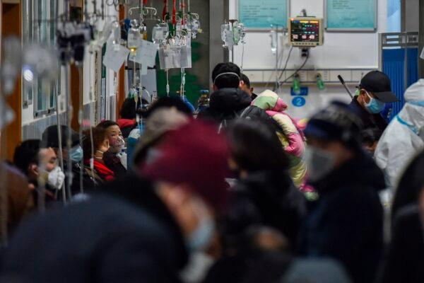 People wearing face masks, to help stop the spread of a deadly virus that began to spread in the city, are seen at Wuhan Red Cross Hospital in Wuhan on Jan. 25, 2020. (Hector Retamal/AFP via Getty Images)