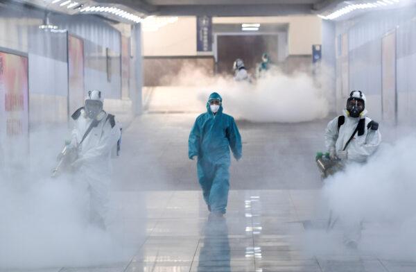 Volunteers in protective suits disinfect a railway station as the country is hit by an outbreak of the new coronavirus, in Changsha, Hunan province, China, on Feb. 4, 2020. (cnsphoto via Reuters)