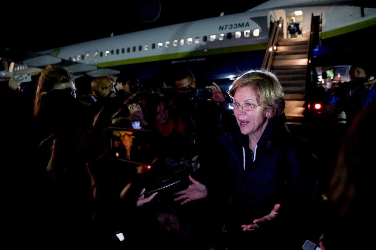 Democratic presidential candidate Sen. Elizabeth Warren (D-Mass.) speaks to members of the media as she arrives at the Manchester-Boston Regional Airport in Manchester, N.H. on Feb. 4, 2020, after traveling from Des Moines, Iowa, following the Iowa caucus. (Andrew Harnik/AP Photo)