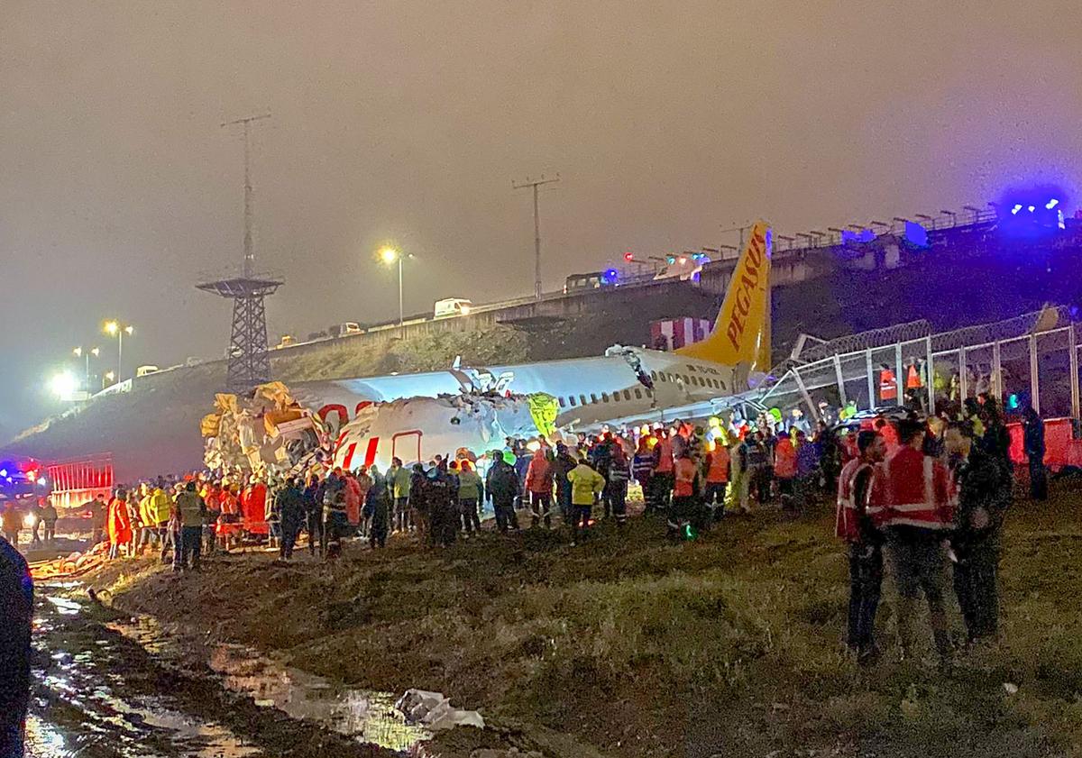 A picture shows the crash site with numerous rescuers at Istanbul's Sabiha Gokcen airport in Turkey on Feb. 5, 2020. (DHA/Demiroren News Agency (DHA)/AFP via Getty Images)