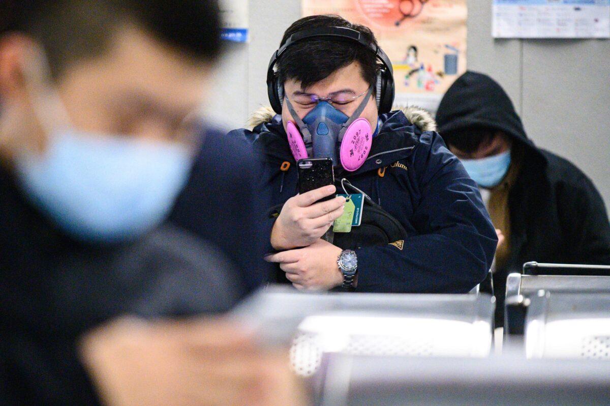 A man wearing a respirator mask waits for his ferry in Hong Kong on Feb. 5, 2020, as a preventative measure following a virus outbreak which began in the Chinese city of Wuhan. (Philip Fong/AFP via Getty Images)