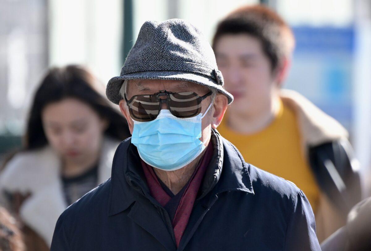 People wear surgical masks in fear of the coronavirus in Flushing, a neighborhood in the New York City borough of Queens, on Feb. 3, 2020. (Johannes Eisele/AFP via Getty Images)