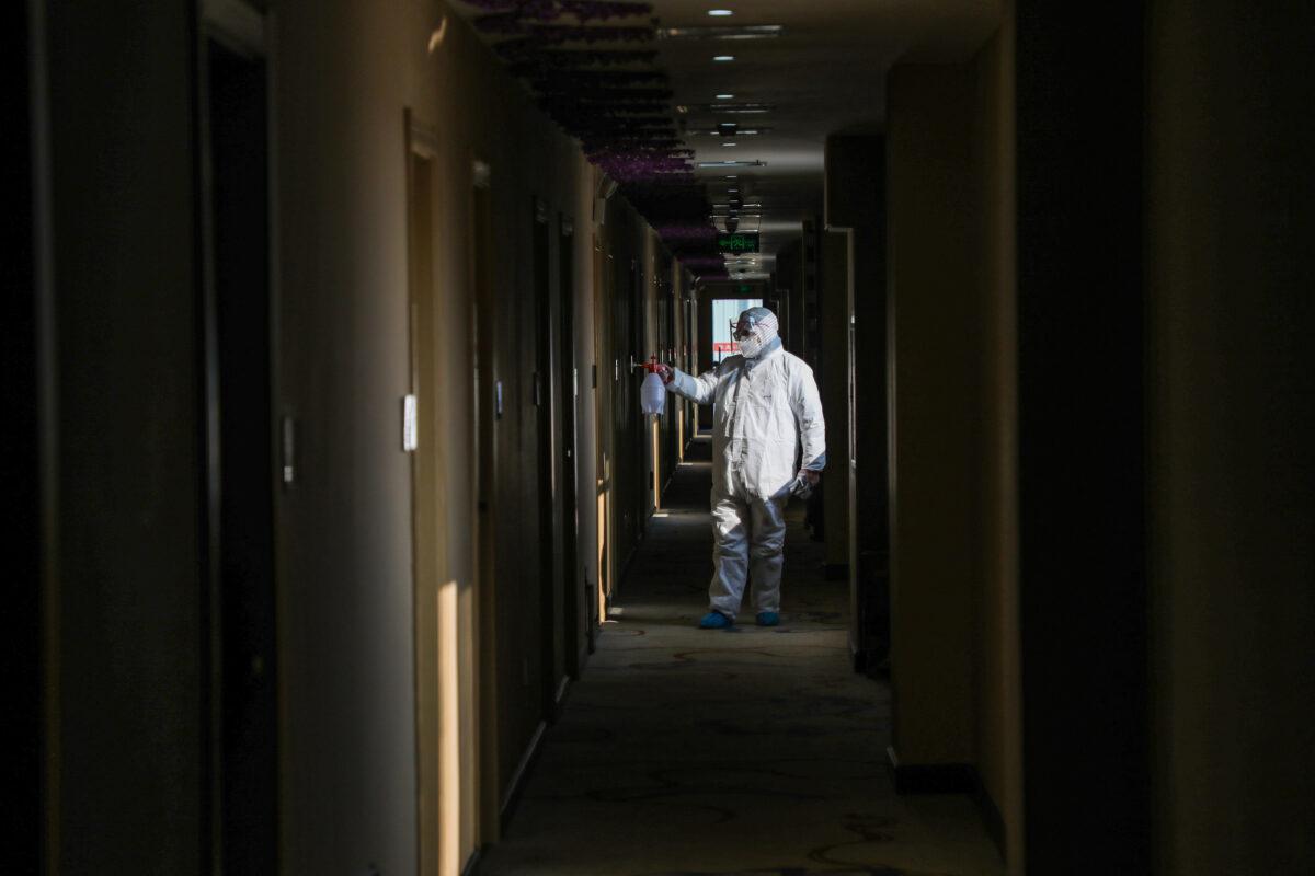 A medical staff member disinfecting at a quarantine zone converted from a hotel in Wuhan, the epicentre of the new coronavirus outbreak, in China's central Hubei province, on Feb. 3, 2020. (STR/AFP via Getty Images)