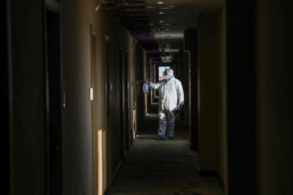 A medical staff member disinfecting at a quarantine zone converted from a hotel in Wuhan, the epicenter of the new coronavirus outbreak, in China's central Hubei province, on Feb. 3, 2020. (STR/AFP via Getty Images)