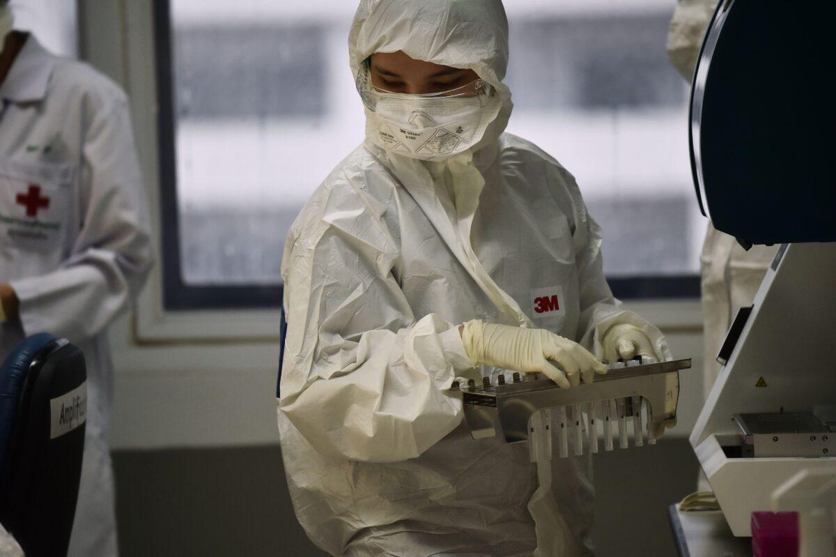 Lab technicians test patient samples for the novel coronavirus at the Centre for Emerging Infectious Diseases of Thailand at Chulalongkorn University in Bangkok on Feb. 5, 2020. (LILLIAN SUWANRUMPHA/AFP via Getty Images)