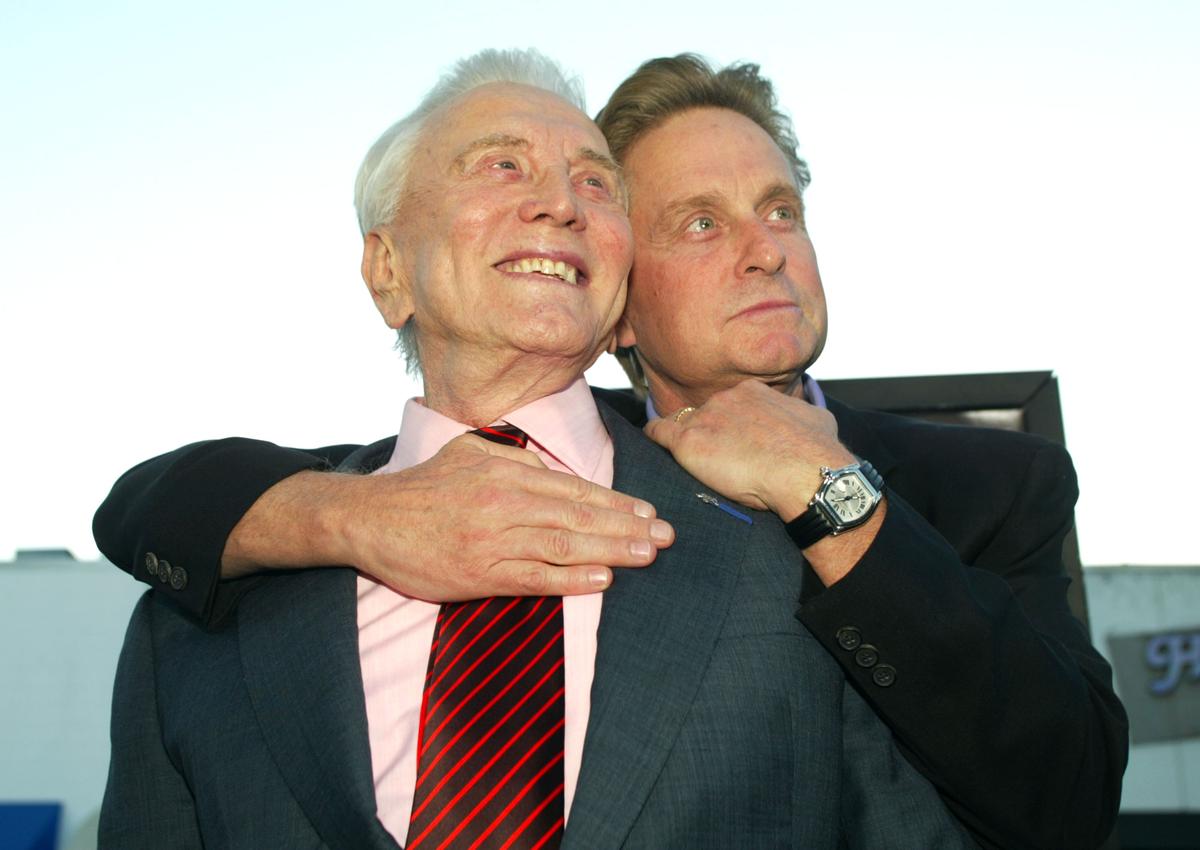 Kirk and Michael Douglas arrive at the premiere of "It Runs In The Family" at the Bruin Theater in Los Angeles on April 7, 2003. (©Getty Images | <a href="https://www.gettyimages.com/detail/news-photo/actor-kirk-douglas-and-son-producer-actor-michael-douglas-news-photo/2268457">Kevin Winter</a>)