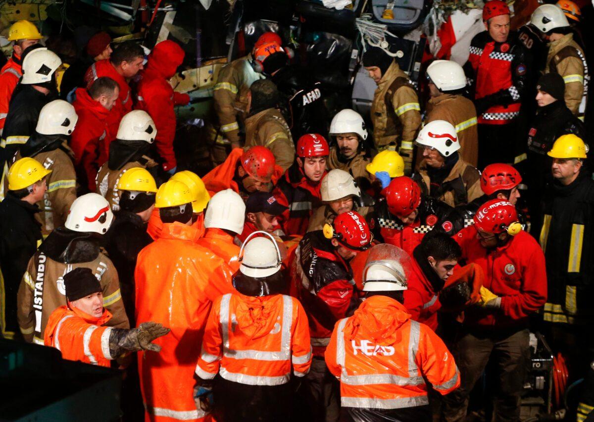 Rescue members evacuate an injured person from the wreckage of a plane after it skidded off the runway at Istanbul's Sabiha Gokcen Airport, in Istanbul, Turkey, on Feb. 5, 2020.(Emrah Gurel/AP)