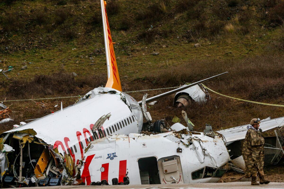 Soldiers guard the wreckage of a plane operated by Pegasus Airlines after it skidded Wednesday off the runway at Istanbul's Sabiha Gokcen Airport, in Istanbul, Turkey, on Feb. 6, 2020. (Emrah Gurel/AP)