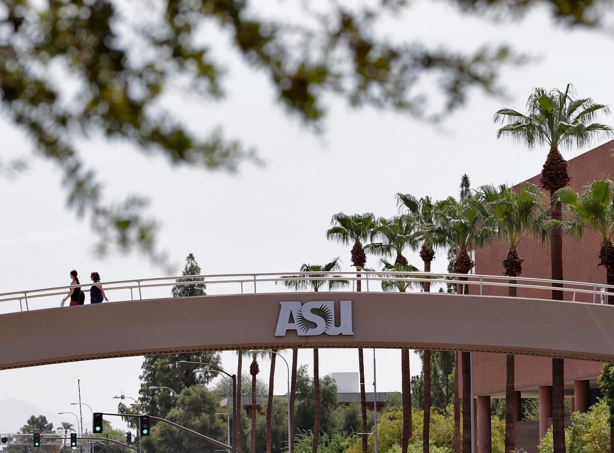Pedestrians cross over University Avenue on the campus of Arizona State University in Tempe, Arizona, U.S. on July 25, 2018. One diagnosis was confirmed at ASU and another at the University of Massachusetts at Boston, which said the infected student had recently traveled to Wuhan. (Matt York/AP)