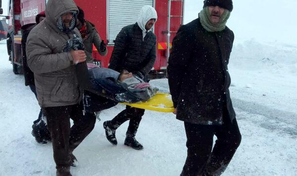 Emergency service members carry a casualty at the site of avalanche near the town of Bahcesehir, in Van province, eastern Turkey, on Feb. 5, 2020. (Yilmaz Sonmez/IHA via AP)