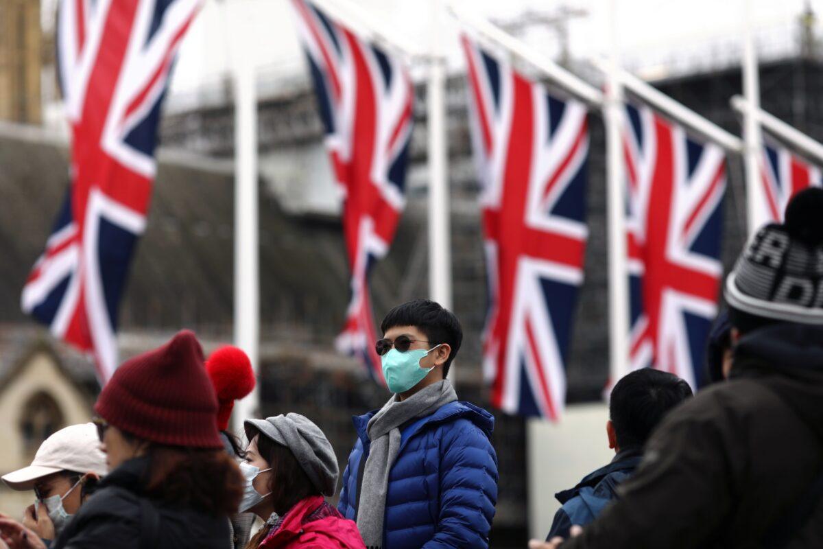 People wearing face masks are pictured on Parliament Square, on Brexit day, in London, Britain, on Jan. 31, 2020. (Simon Dawson/Reuters)