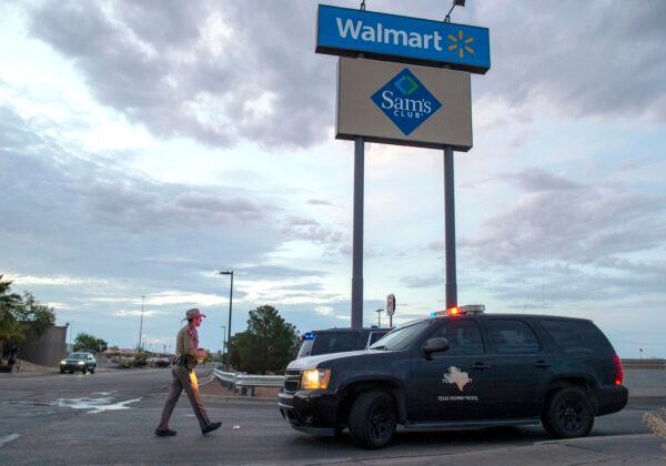 A Texas State Trooper walks back to his car while providing security outside the Walmart store in the aftermath of a mass shooting in El Paso, Texas, on Aug. 4, 2019. (Andres Leighton/AP)